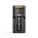 Nitecore UM2 dual-slot USB-C fast charger with LCD display charging two 18650 batteries side by side.