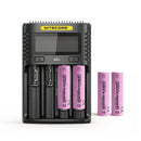 NITECORE UMS4 4-slot LCD smart charger with 4x EVE 30P 3000mAh 30A flat top 18650 batteries – high-output power kit with LCD control for drones and field videography.