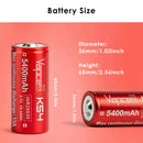 Vapcell K54 26650 batteries next to digital multimeter reading voltage
