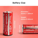Vapcell K54 26650 batteries next to digital multimeter reading voltage